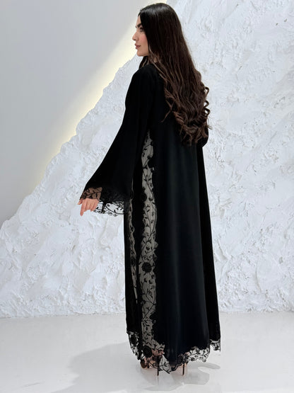 Person wearing a Premium Black Hand-Embellished Abaya made from Nida fabric and Sheer Mesh Panel outfit on a white background