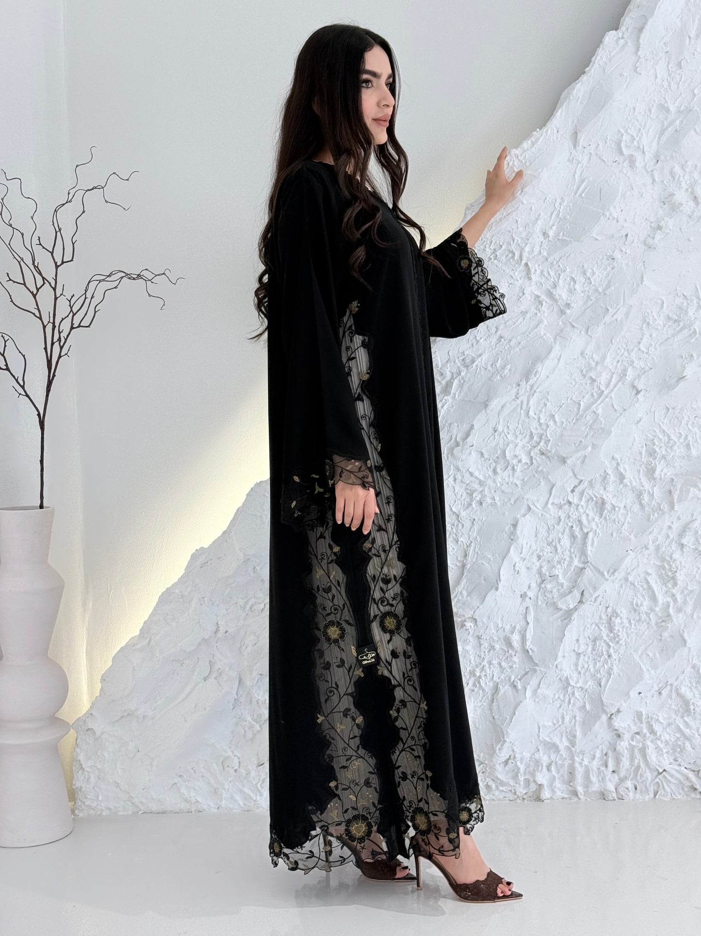 Person wearing a Premium Gold Hand-Embellished Abaya made from Nida fabric and Sheer Mesh Panel outfit on a white background