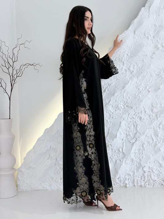 Person wearing a Premium Gold Hand-Embellished Abaya made from Nida fabric and Sheer Mesh Panel outfit on a white background
