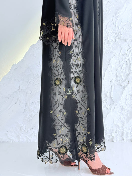 Person wearing a Premium Gold Hand-Embellished Abaya made from Nida fabric and Sheer Mesh Panel outfit on a white background