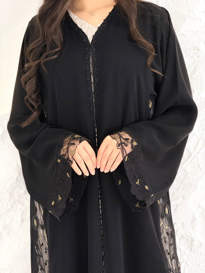 Person wearing a Premium Gold Hand-Embellished Abaya made from Nida fabric and Sheer Mesh Panel outfit on a white background