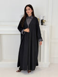 A woman wearing a Black with Charcoal Contrast made from Premium Ice Cool Fabric in a white room.
