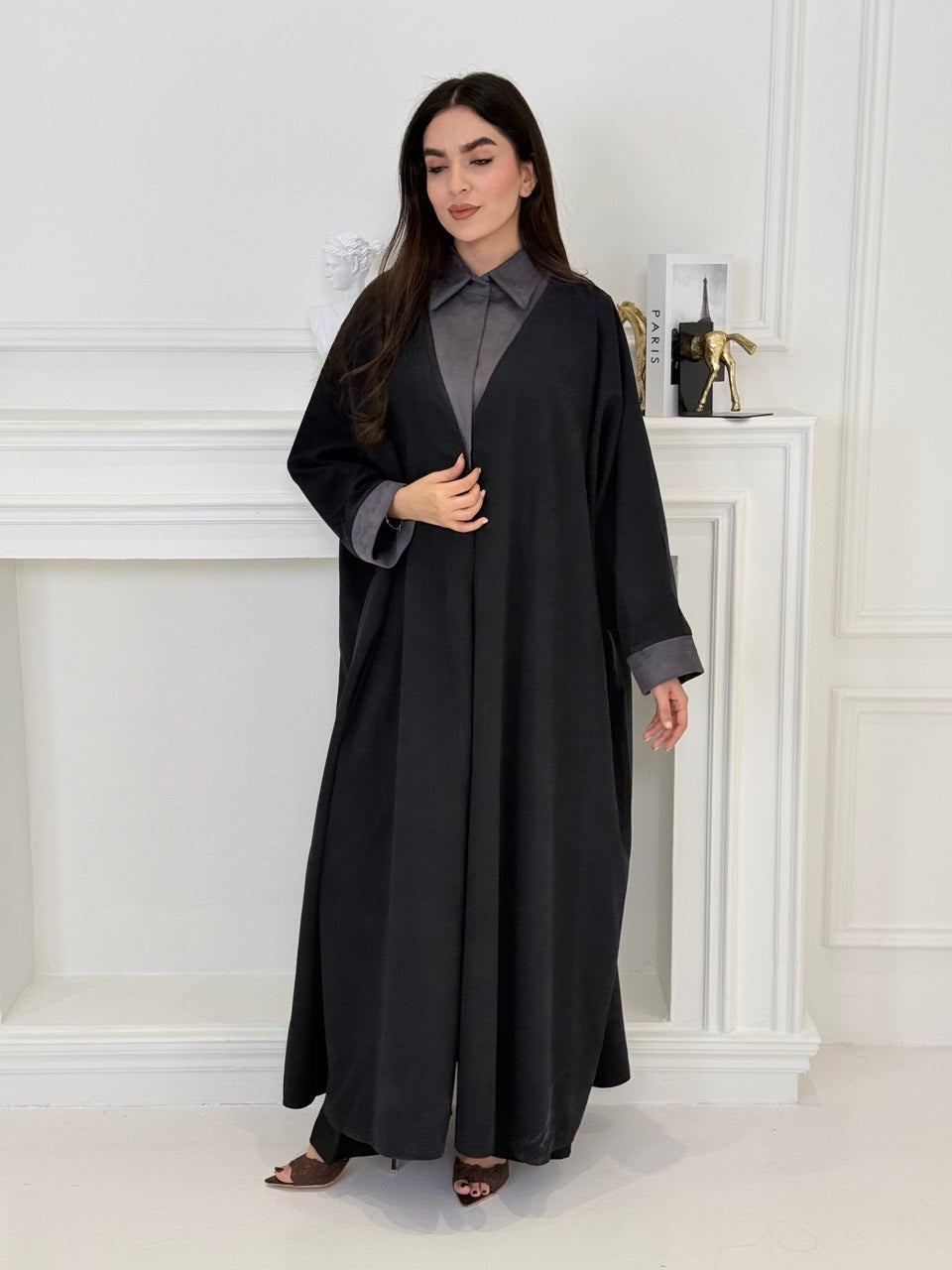 A woman wearing a Black with Charcoal Contrast made from Premium Ice Cool Fabric in a white room.
