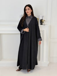 A woman wearing a Black with Charcoal Contrast made from Premium Ice Cool Fabric in a white room.
