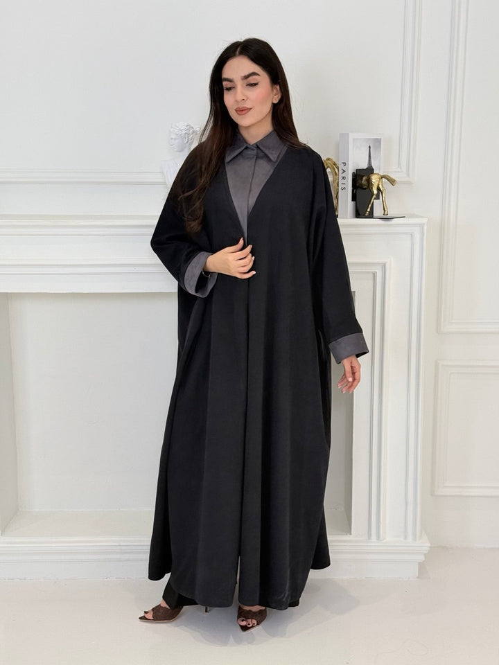 A woman wearing a Black with Charcoal Contrast made from Premium Ice Cool Fabric in a white room.