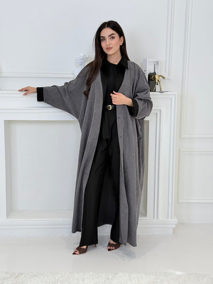 A woman wearing a Grey with Black Contrast Contrast made from Premium Ice Cool Fabric in a white room.