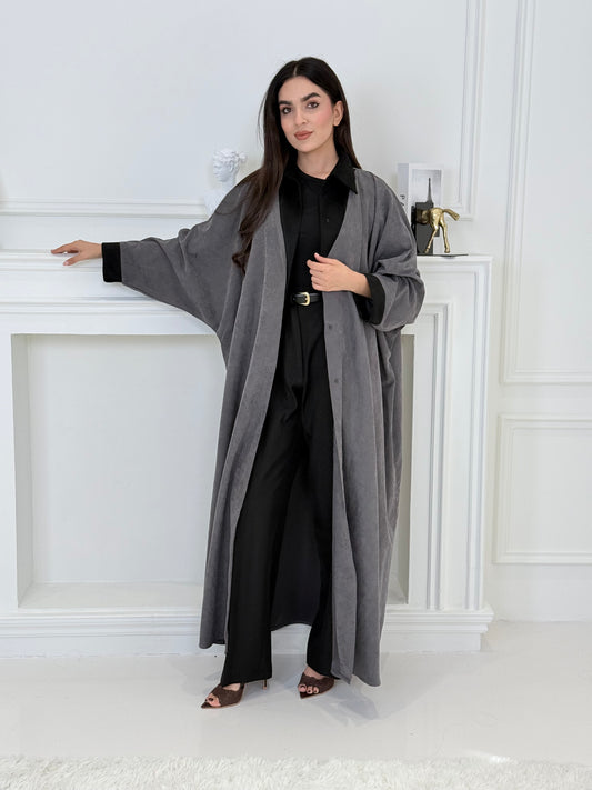 A woman wearing a Grey with Black Contrast Contrast made from Premium Ice Cool Fabric in a white room.