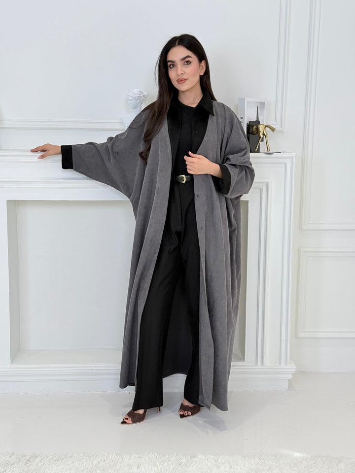 A woman wearing a Grey with Black Contrast Contrast made from Premium Ice Cool Fabric in a white room.