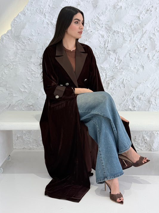 Woman wearing a Premium dark brown Velvet coat abaya on a light gray background