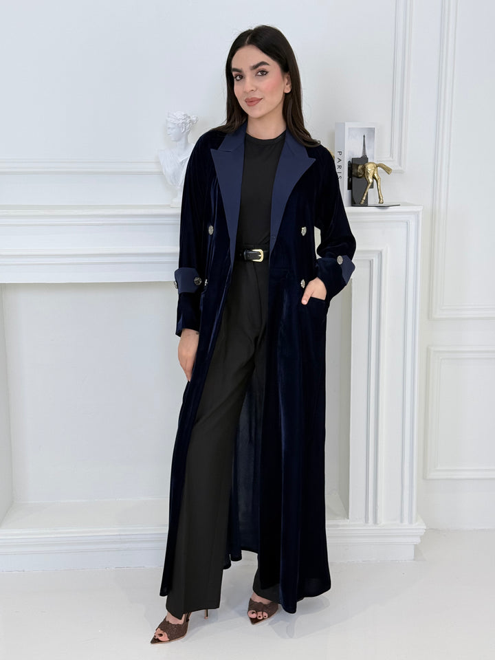 Woman wearing a Premium navy blue Velvet coat abaya on a light gray background