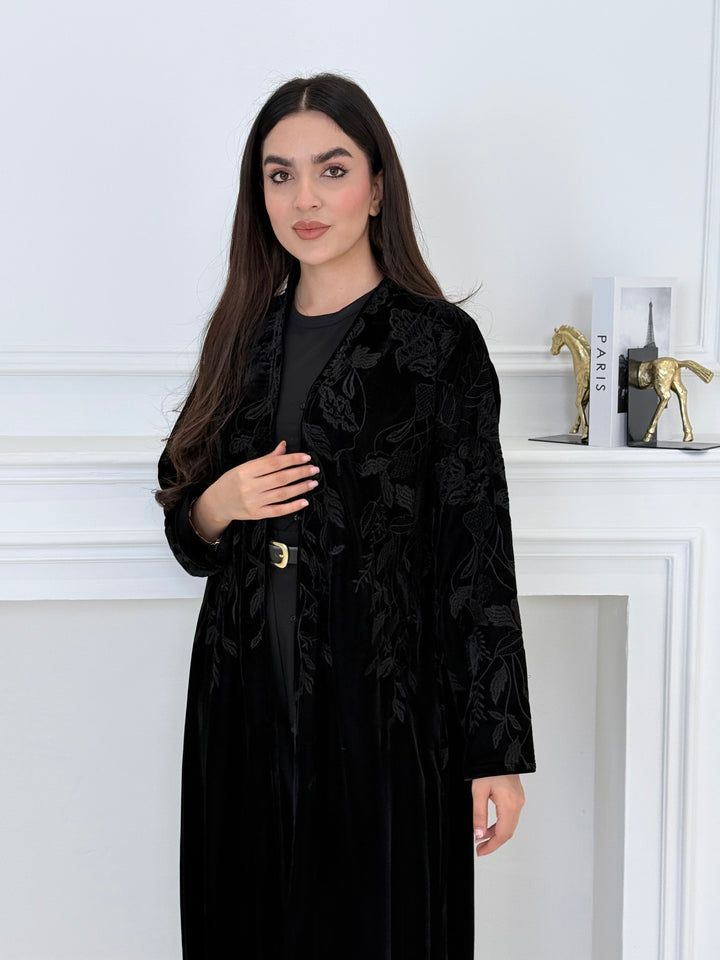 Woman wearing a Black Embroidered Velvet Abaya coat with a white background