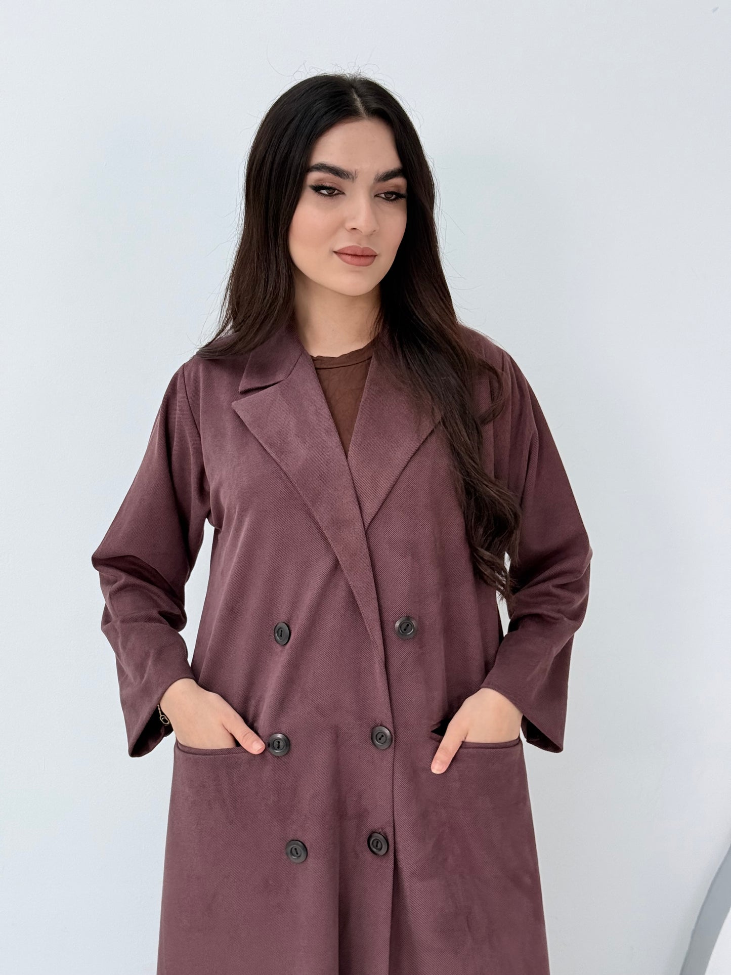 Woman wearing a Premium maroon burgundy Shamwa coat abaya against a white background