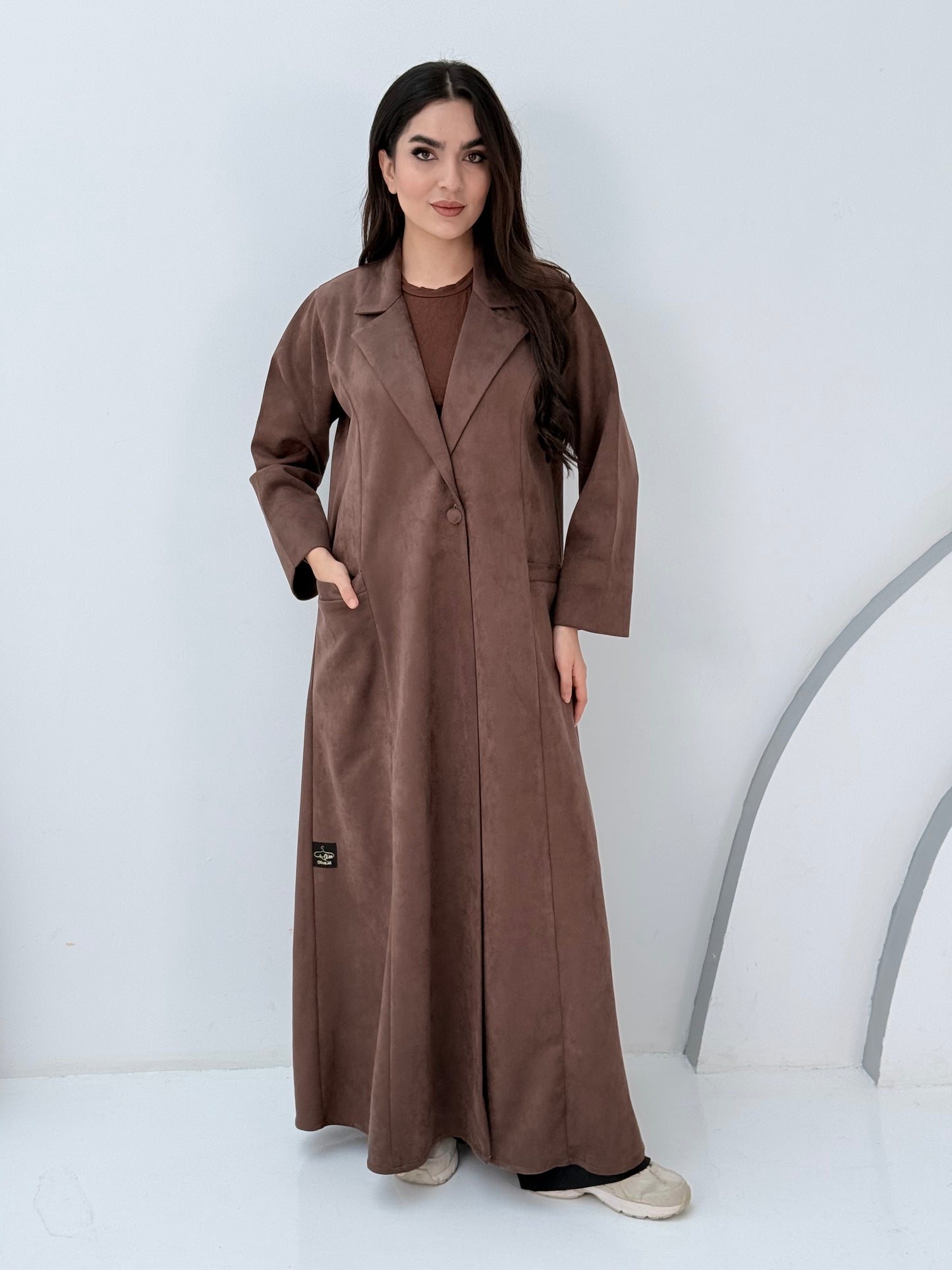 Woman wearing a Premium Cocoa Brown Shamwa Coat Abaya on a white background