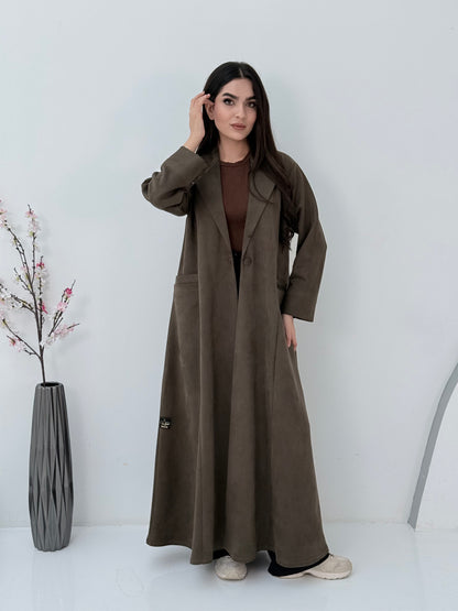 Woman wearing a Premium dark olive Shamwa Coat Abaya on a white background