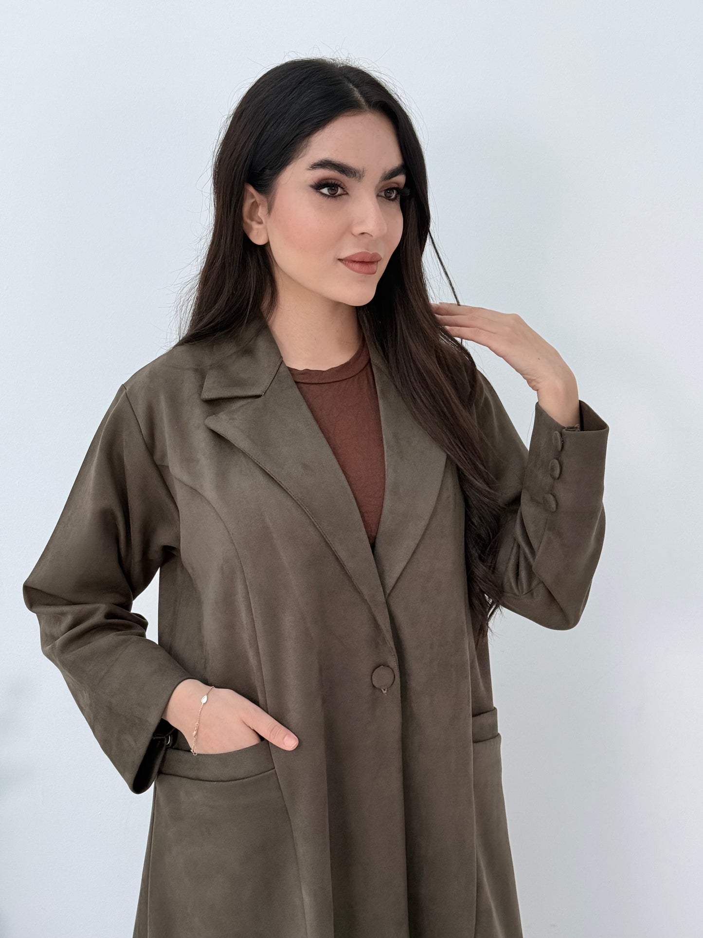Woman wearing a Premium dark olive Shamwa Coat Abaya on a white background