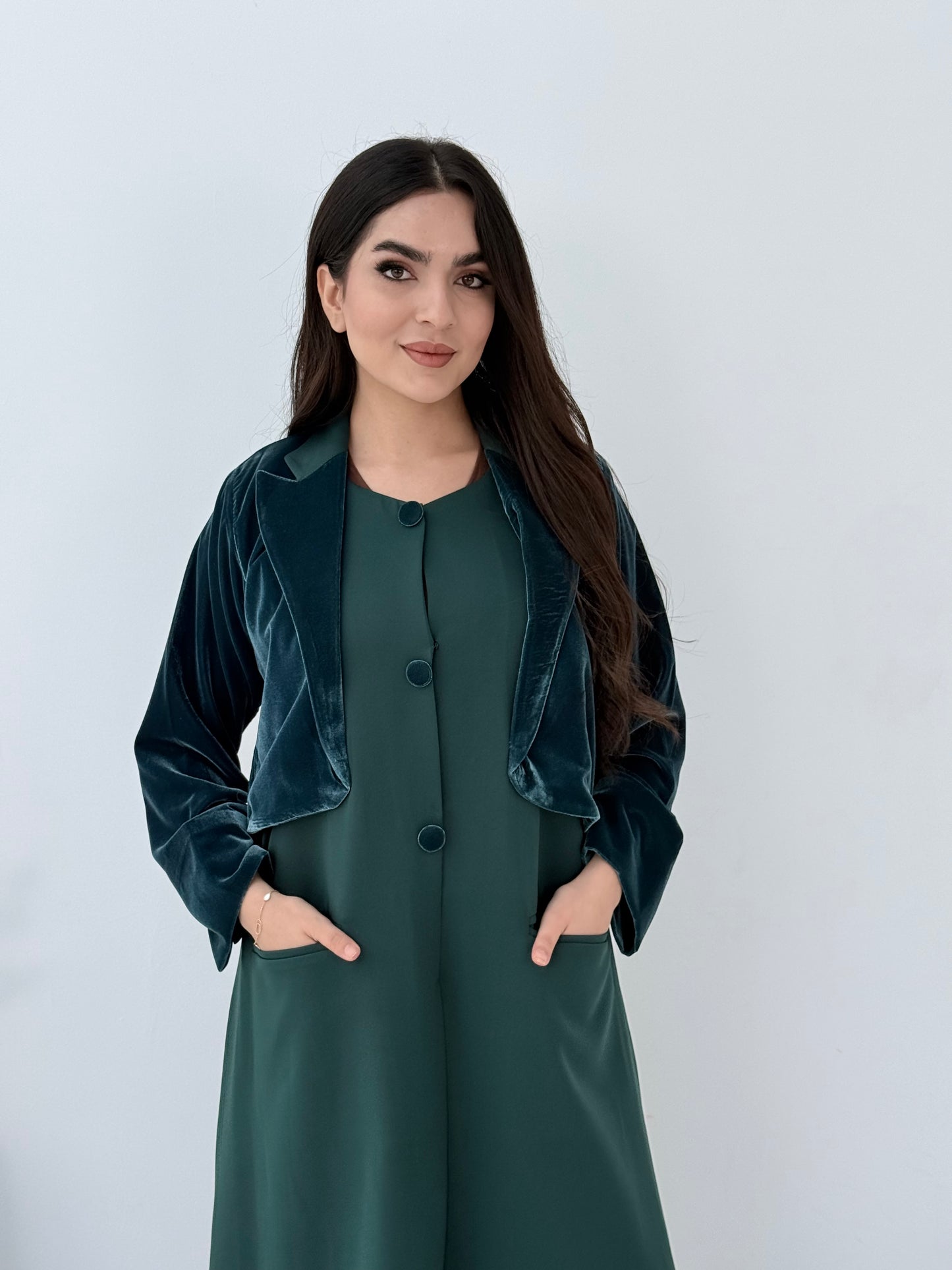 Woman wearing a long Emerald Green Dual-Texture Abaya with a matching jacket against a white background