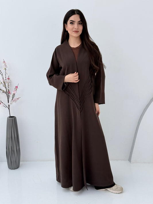 Woman wearing a long Premium dark brown Crepe Abaya with Pleated Waist dress on a white background