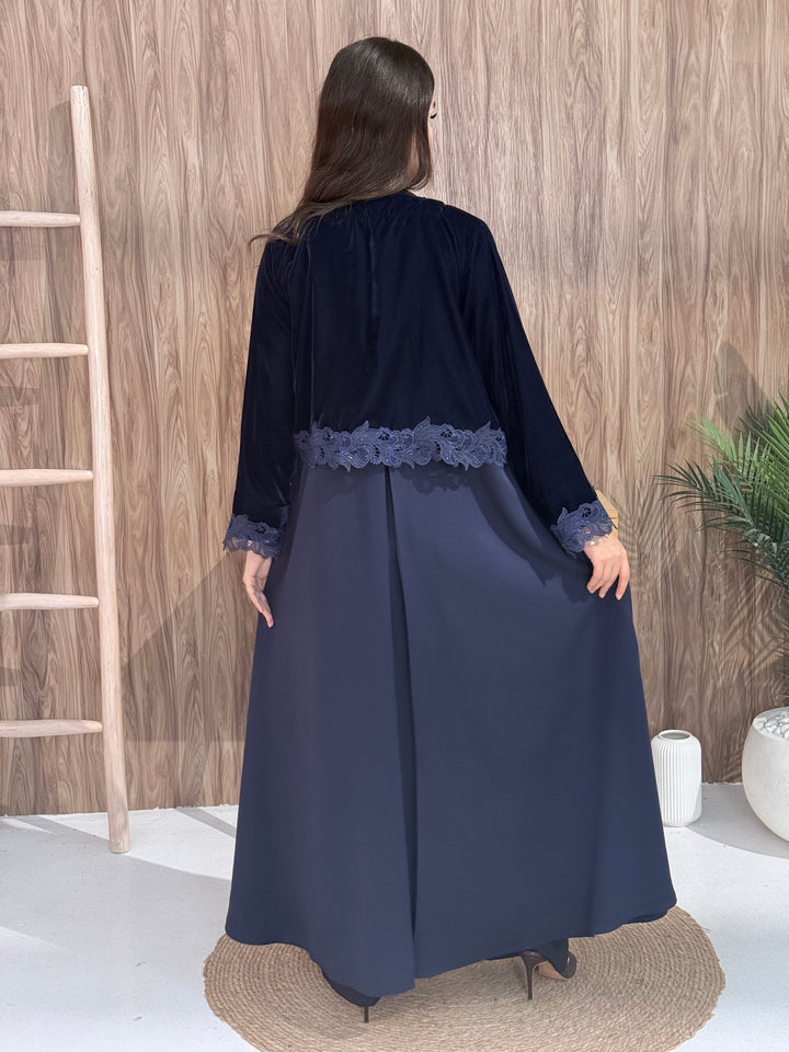 Woman in a Premium navy blue velvet Crepe and Velvet abaya on a wooden background