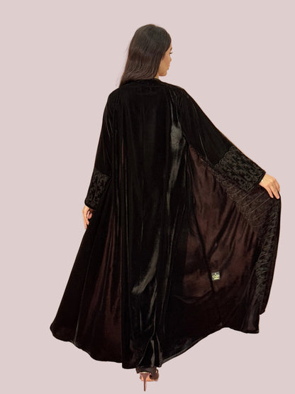 Premium Black Velvet Abaya with Front Embroideryon a pink background
