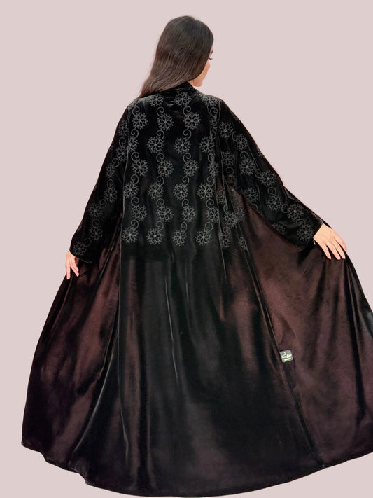 Embroidered Premium Black Velvet Abaya against a pink background