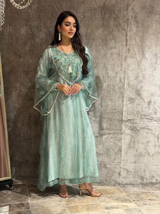 Woman in a light blue traditional outfit with floral patterns on a textured brown background
