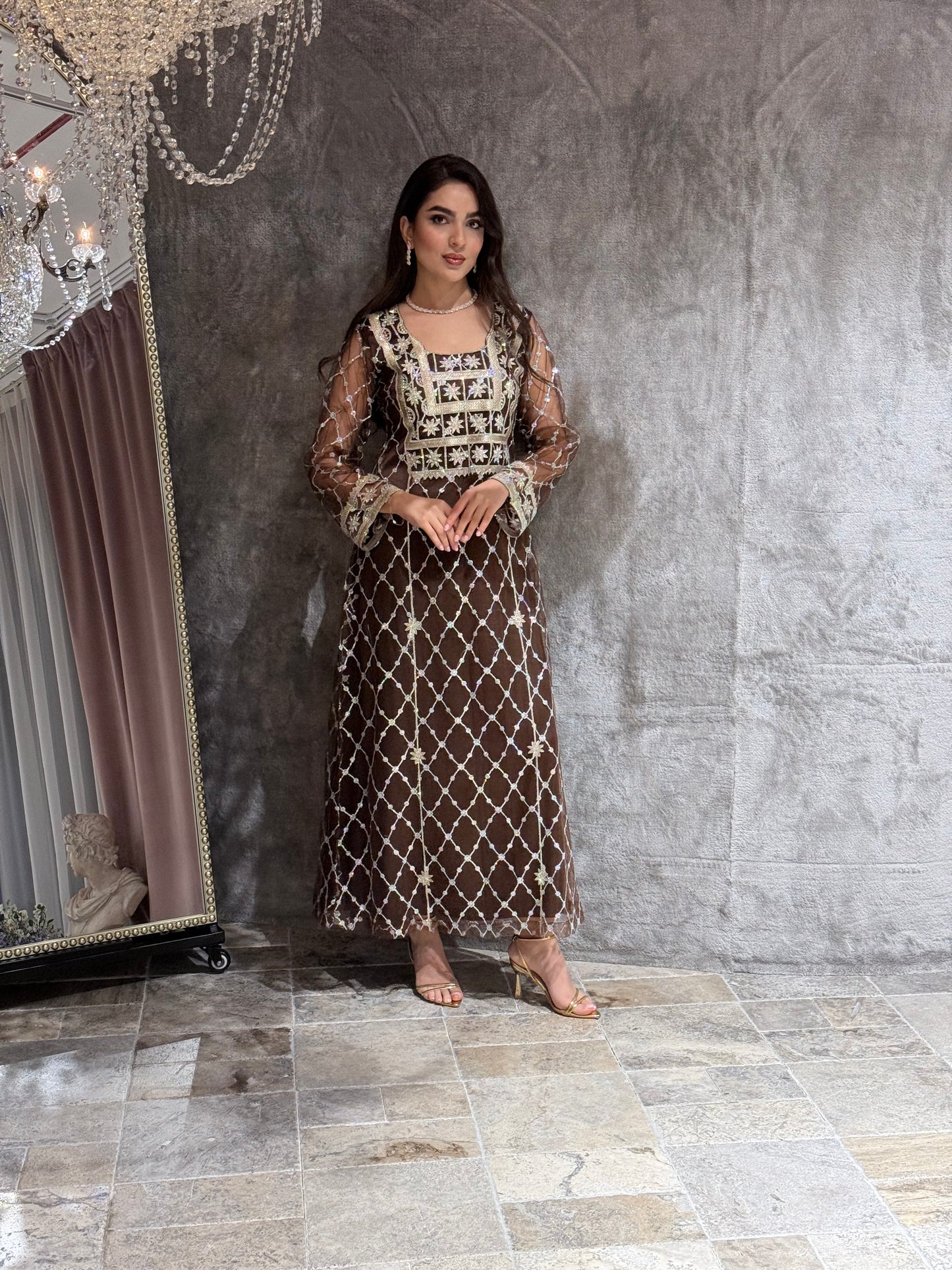 Woman in a luxury Dark Brown Embroidered Tulle kaftan Dress with Stone Detailing standing on a marble floor