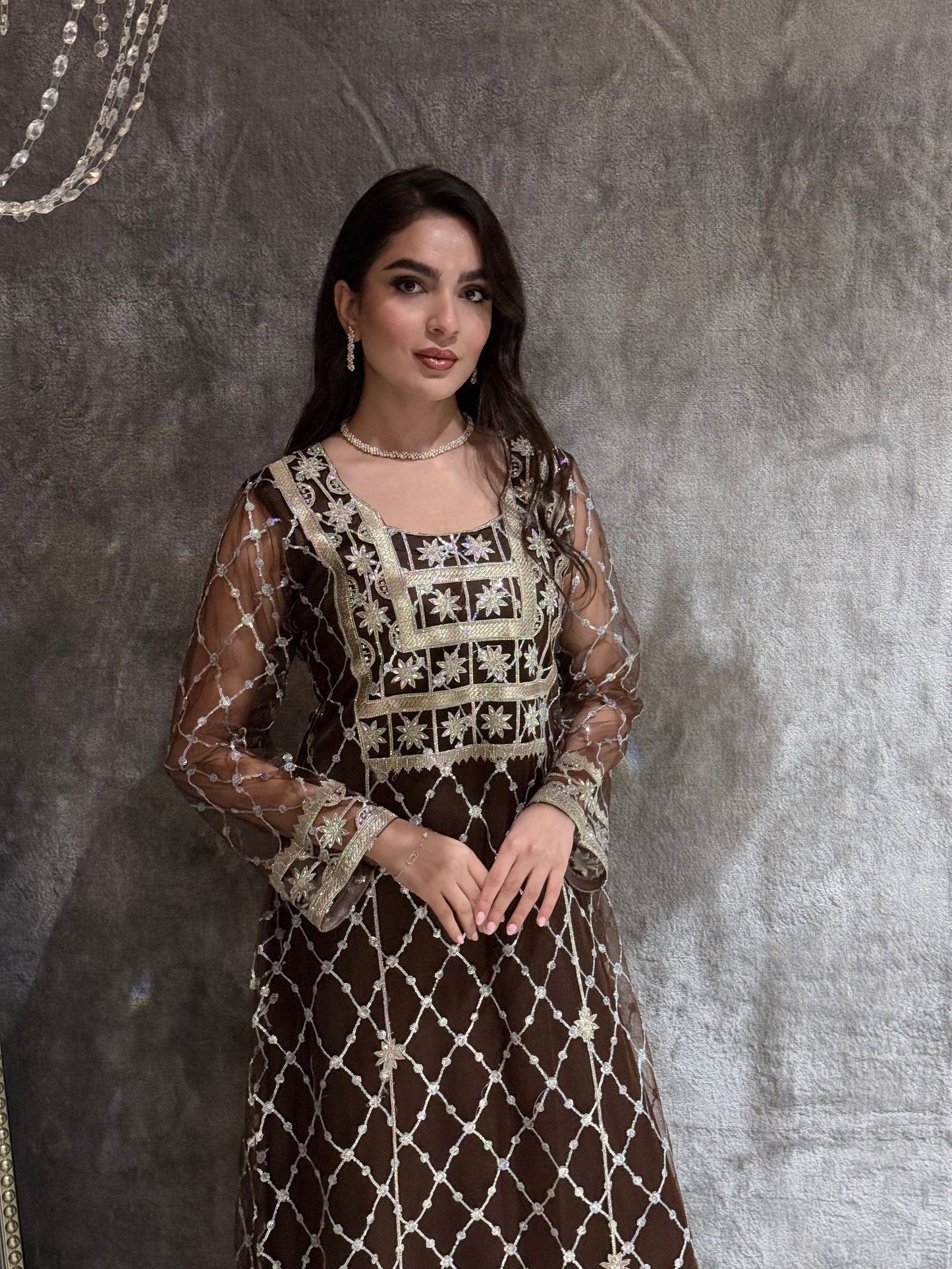 Woman in a luxury Dark Brown Embroidered Tulle kaftan Dress with Stone Detailing standing on a marble floor