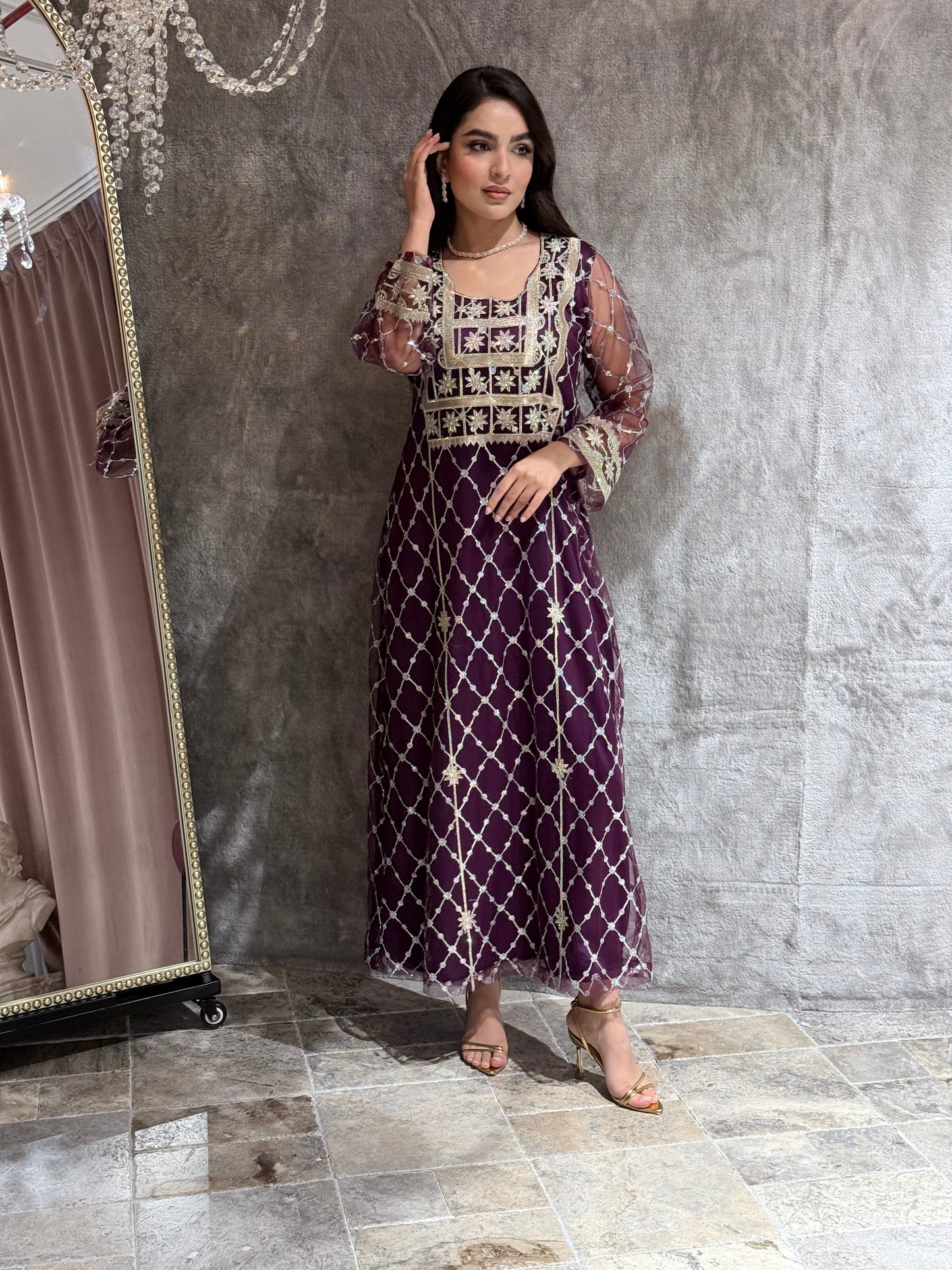 Woman in a luxury deep purple Embroidered Tulle kaftan Dress with Stone Detailing standing on a marble floor