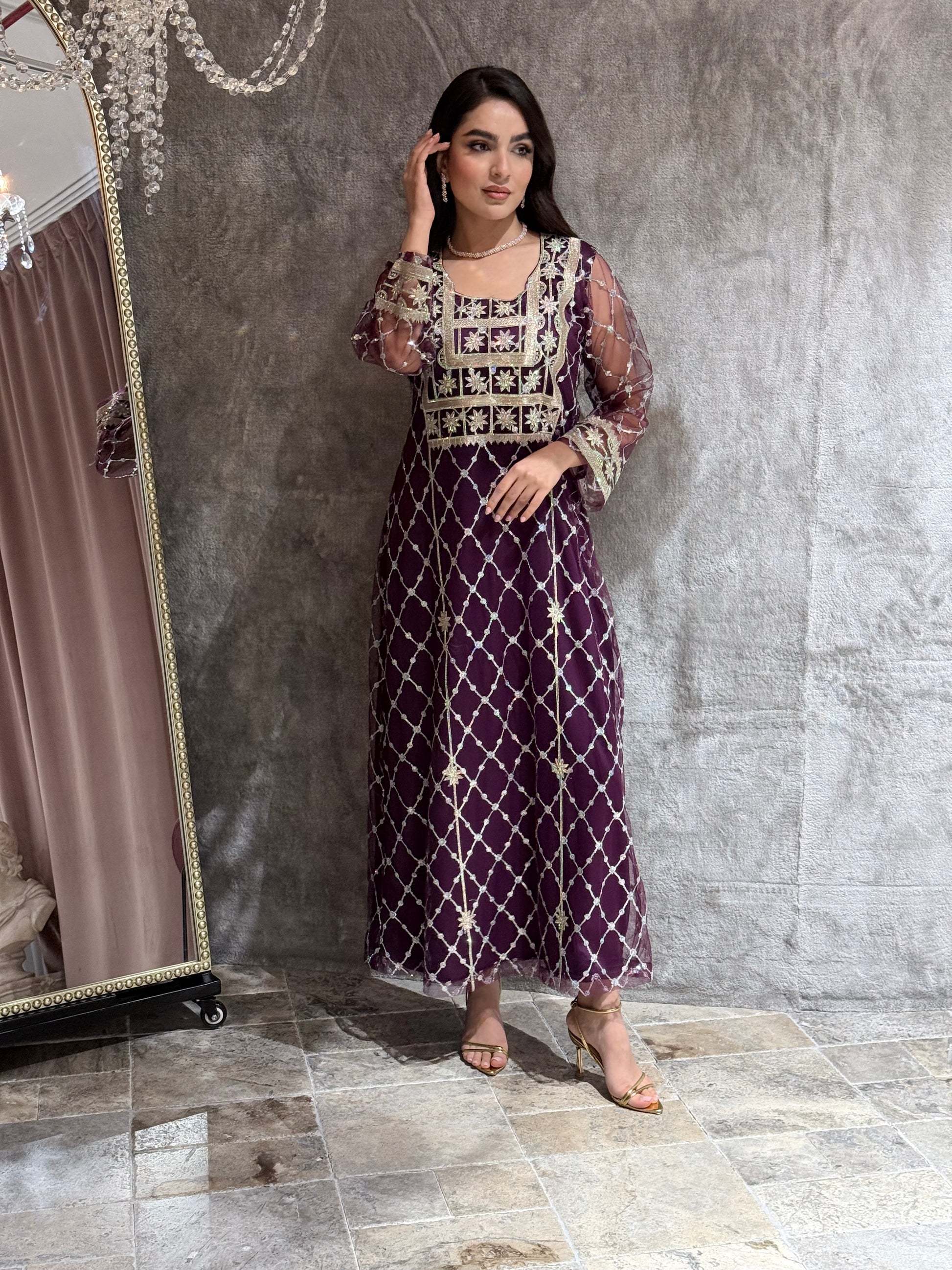 Woman in a luxury deep purple Embroidered Tulle kaftan Dress with Stone Detailing standing on a marble floor