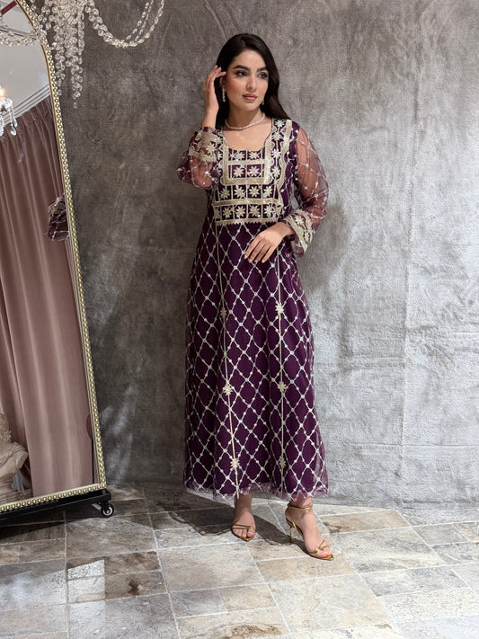 Woman in a luxury deep purple Embroidered Tulle kaftan Dress with Stone Detailing standing on a marble floor