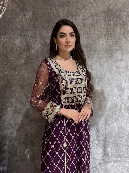 Woman in a luxury deep purple Embroidered Tulle kaftan Dress with Stone Detailing standing on a marble floor