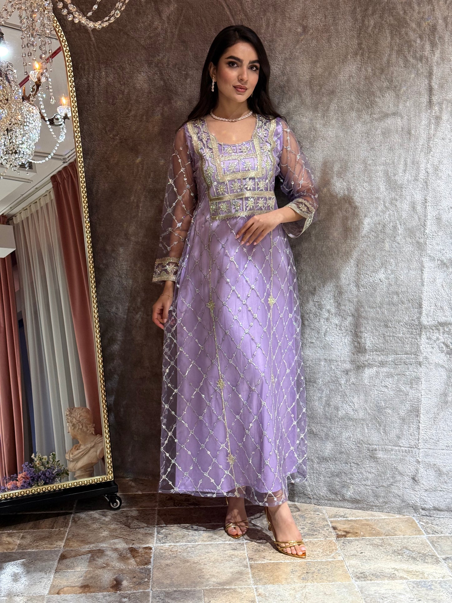 Woman in a luxury lavender Embroidered Tulle kaftan Dress with Stone Detailing standing on a marble floor