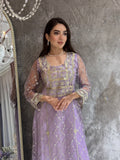 Woman in a luxury lavender Embroidered Tulle kaftan Dress with Stone Detailing standing on a marble floor