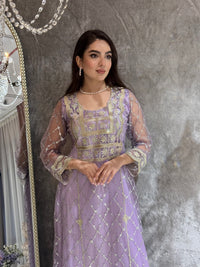 Woman in a luxury lavender Embroidered Tulle kaftan Dress with Stone Detailing standing on a marble floor