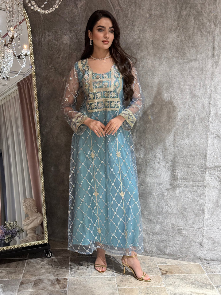 Woman in a luxury tiffany blue Embroidered Tulle kaftan Dress with Stone Detailing standing on a marble floor