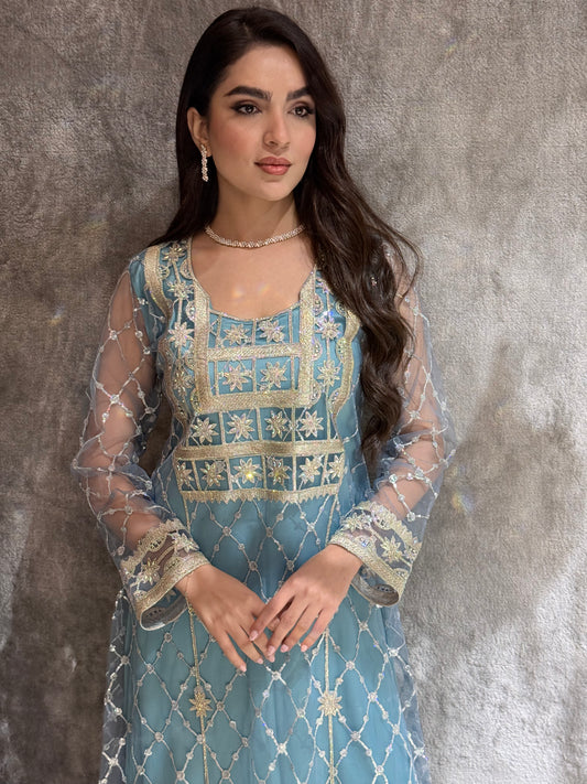 Woman in a luxury tiffany blue Embroidered Tulle kaftan Dress with Stone Detailing standing on a marble floor