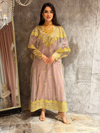 Woman in a Light Purple Embroidered Tulle kaftan  Dress on a textured surface