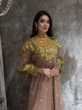 Woman in a coffee brown Embroidered Tulle kaftan dress standing in front of a mirror.