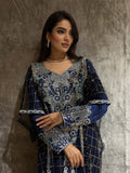 Woman wearing a Navy Blue Emirati Design Tulle kaftan Dress outfit on a textured floor.