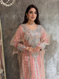 Woman in a Pink Emirati Design Tulle kaftan Dress outfit standing in front of a mirror.