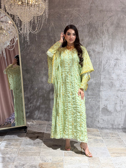 Woman wearing a Mint Green Luxury Embroidered Kaftan Dress in a room with gray tiles.