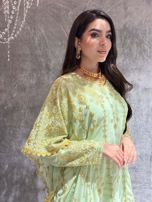 Woman wearing a Mint Green Luxury Embroidered Kaftan Dress in a room with gray tiles.