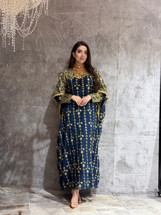 Woman wearing a Navy Blue Luxury Embroidered Kaftan Dress on a gray background