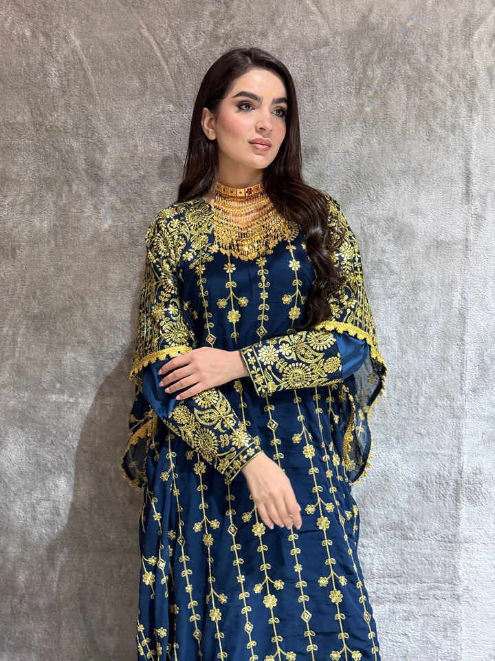 Woman wearing a Navy Blue Luxury Embroidered Kaftan Dress on a gray background