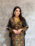 Woman in a  Black Floral Embroidered Kaftan lying on a textured surface