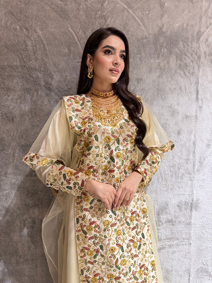 Woman standing on a textured gray floor wearing a Cream Floral Embroidered Kaftan
