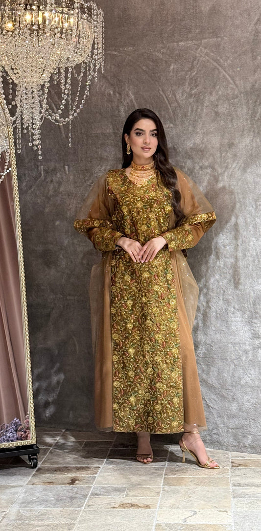 Woman in a Golden Brown Floral Embroidered Kaftan standing on a reflective floor with a chandelier in the background