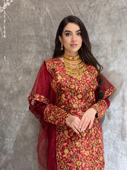 Woman in a Maroon Floral Embroidered Kaftan outfit lying on a tiled floor.