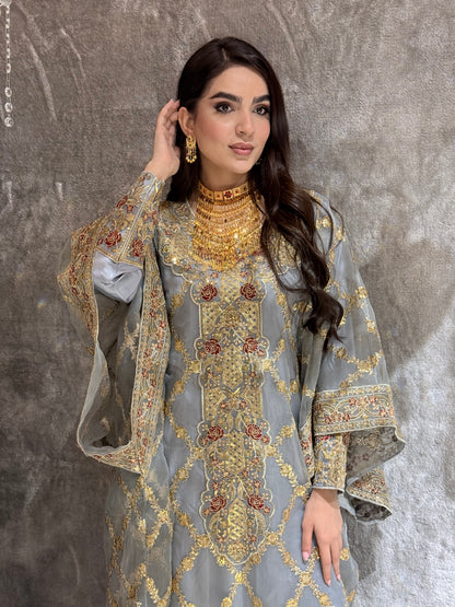 Woman wearing a Grey Luxury Embroidered Kaftan traditional outfit on a textured surface