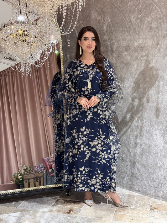 Woman in a Navy Blue Floral Embroidered Kaftan lying on a textured surface
